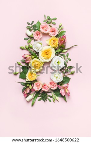 March 8th concept. Creative layout made of colorful rose flowers on pink background. Greeting Card Women's Day on March 8th. Royalty-Free Stock Photo #1648500622