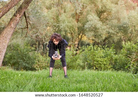 Photographer as landscape photographer with medium format camera in a meadow