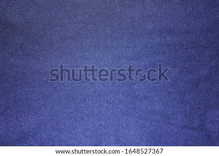Texture background of dark blue fabric. Empty cloth surface of blue cotton material, close up view of casual shirt detail 