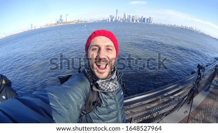 handsome man taking selfie in manhattan during winter holidays in New York City