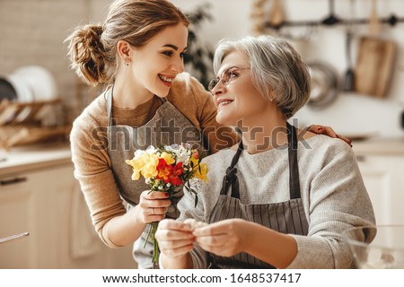 happy mother's day! family old grandmother mother-in-law and daughter-in-law daughter congratulate on the holiday, give flowers 
 Royalty-Free Stock Photo #1648537417