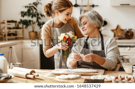 happy mother's day! family old grandmother mother-in-law and daughter-in-law daughter congratulate on the holiday, give flowers 
 Royalty-Free Stock Photo #1648537429