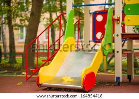 Small slide on autumn kids playground