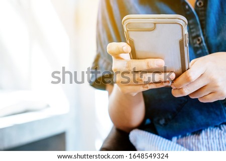 image of people using a smartphone.
