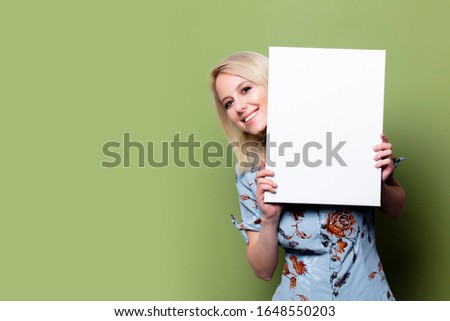 Blonde woman with white banner on green background 