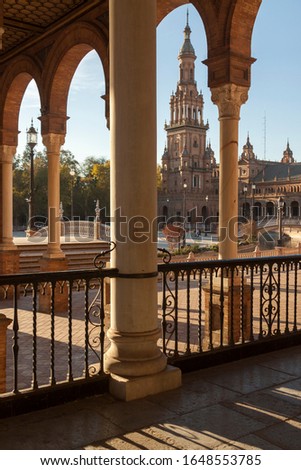 Details of the architecture and decoration in the Plaza de España in Seville with warm orange light at sunset.
