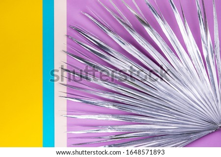 Silver shining palm branch on a colorful geomitric background. Style of 1920th years  in modern update.