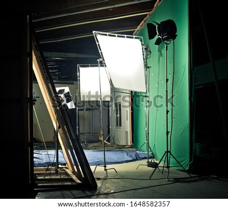 Shooting studio with green screen and professional equipment