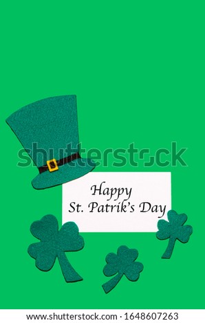 Irish national tradition. St. Patrick's Day. green hat, leaves of clover, shamrock on background with copy space with inscription, text. vertical postcard. soft focus