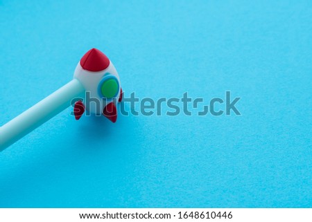 Cute rocket pen for children on blue background with copy space. Back to school, learning or education concept. Imagination is more important than knowledge.
