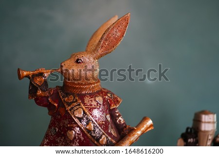 
Rabbit figurine playing trumpet with green background. 