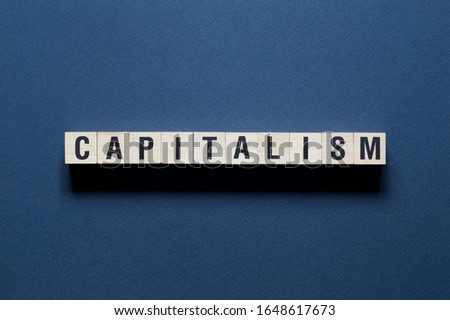 Capitalism Word Written In Wooden Cube