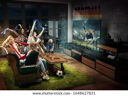 Group of friends watching TV, match, championship, sport games. Emotional men and women cheering for favourite football team of Germany with flag. Concept of friendship, sport, competition, emotions.