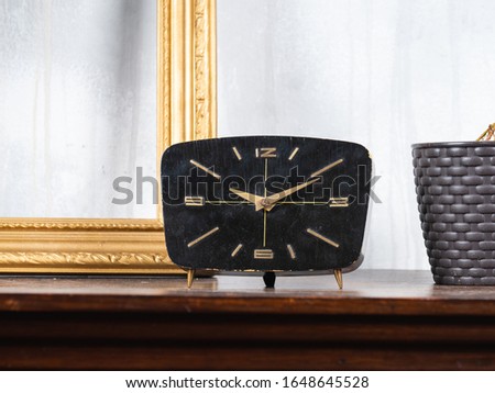 Black retro clock on a table