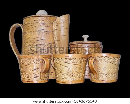 Cups, sugar bowl and kettle of birch bark. Kitchenware. Folk craft of Russia. Products from Birch bark were made by most societies well before pottery was invented. Isolated on a black background