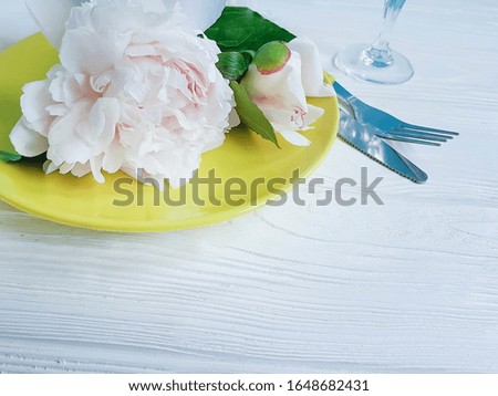 peony flower, plate on a wooden background