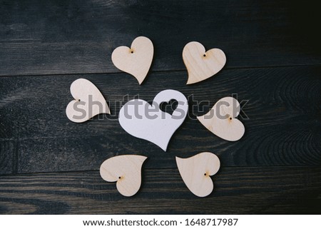wooden hearts placed nicely on a brown vintage wood background