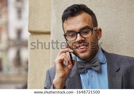 smiling businessman talking on the phone, he has good news