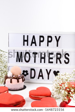 Happy Mother's Day lightbox wording plus mini cake dripping dessert. Spring Flowers and simple clean background