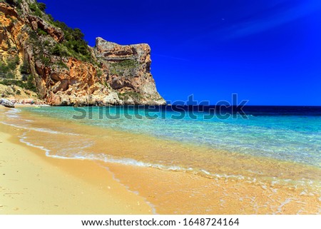 Beautiful seascape with beach and rock in Spain by the sea, Cala Moraig, Cumbre del Sol