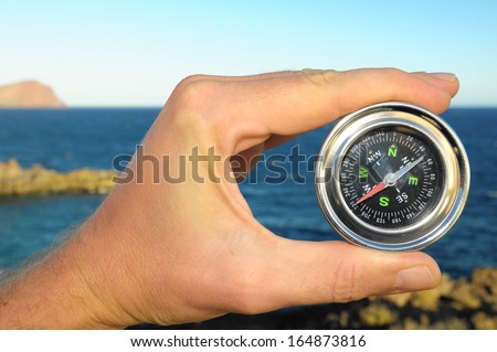 Orientation Concept Male Hand Holding a Metal Compass