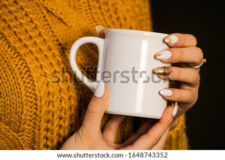hand holding cup of tea