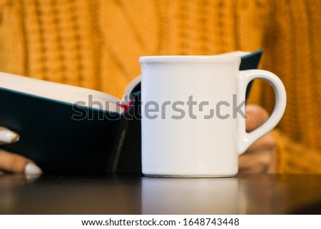 hand holding cup of tea