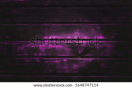 A Dark  purple olor wooden background.