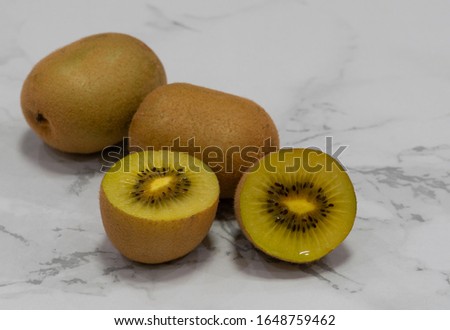 Fresh kiwifruit on marble table top
