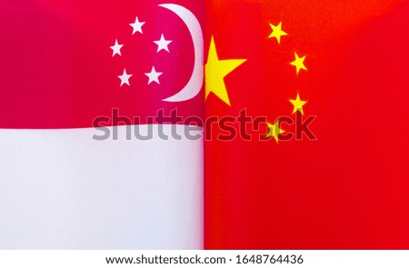 fragments of national flags of the Republic of Singapore and China in close-up