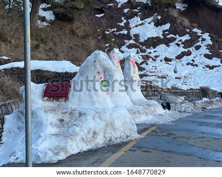 Snow horses along the road in Murree Pakistan. These sculptures are a source of income for locals who rent these sculptures to tourists for pictures.