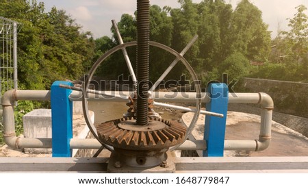 The surface of a gear wheel in a dam's water discharge regulator machine