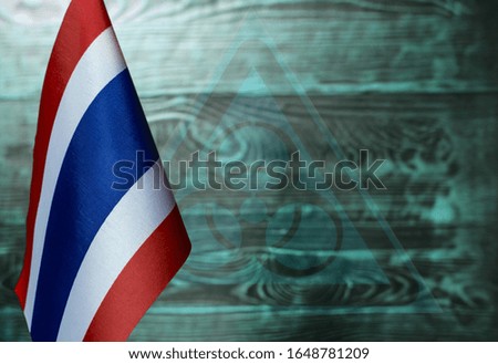 fragment of the national flag of Thailand on a green background with a transparent biohazard sign