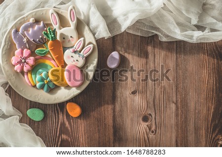 Happy Easter. Multi-colored pastel easter cookies on a wooden background. Easter concept