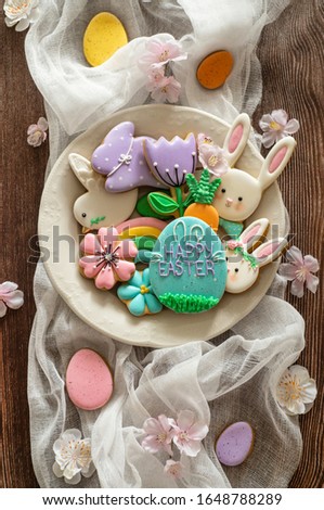 Happy Easter. Multi-colored pastel easter cookies on a wooden background. Easter concept