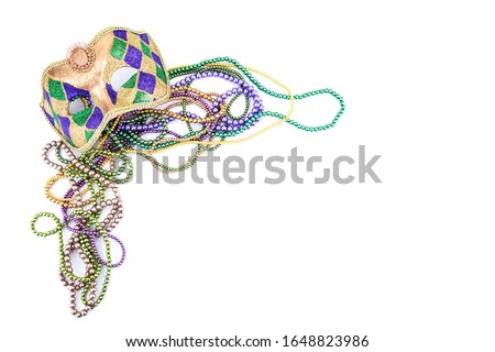 holiday or mardi gras beads and mask making frame isolated on white background