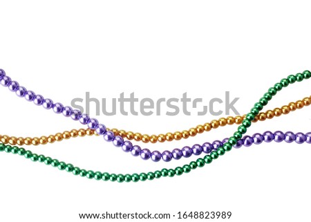 Three colors mardi gras beads for decoration isolated ob white background
