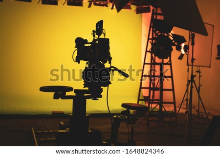 Shooting studio with professional equipment and yellow/green screen