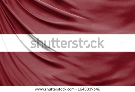 Realistic flag of Latvia on the wavy surface of fabric