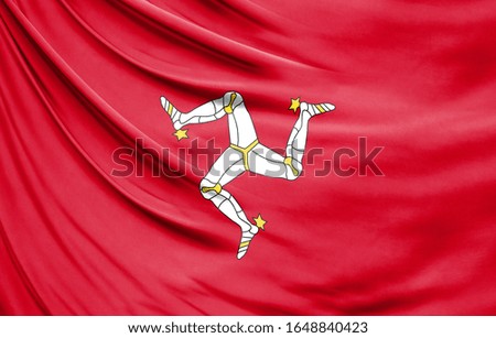 Realistic flag of Isle Of Man on the wavy surface of fabric