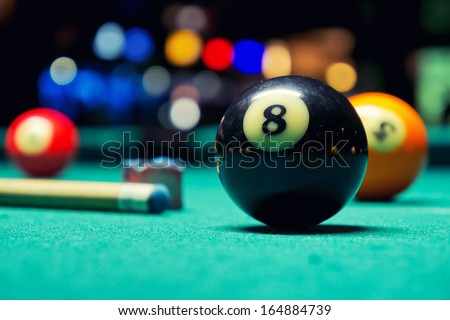 Billiard Balls / A Vintage style photo from a billiard balls in a pool table. Noise added for a film effect Royalty-Free Stock Photo #164884739