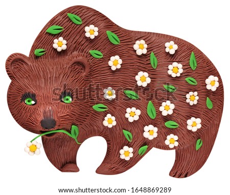 Big brown bear, emerged from hibernation and wanders through the spring forest in search of food, glued from plasticine