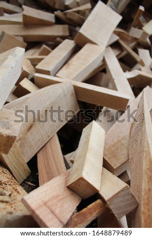 Stack of cut firewood of different size close up.