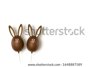 Easter chocolate eggs isolated on white background, top view. Sweet Easter stick candy, chocolate flavour, funny bunny egg. Rabbit bunny dessert, on white table, top view.