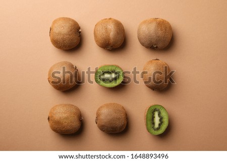Flat lay with kiwi on craft brown background, top view