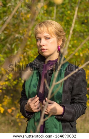 portrait of attractive young woman, on a background autumn leaves