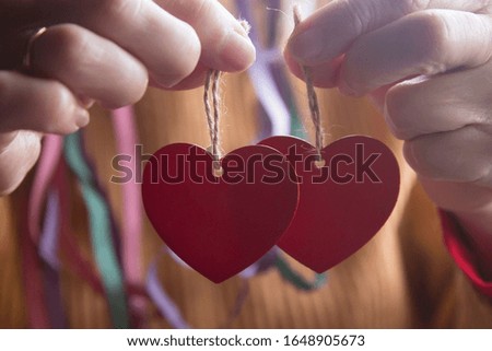 woman holding heart shaped tags