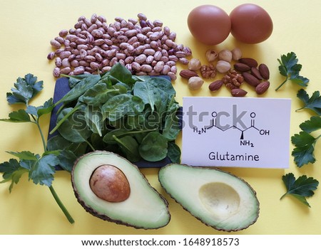 Food rich in glutamine with structural chemical formula of glutamine molecule. Food for training and exercise: spinach, eggs, parsley, carrot, beans, almond, walnut. Bodybuilding, sport nutrition. Royalty-Free Stock Photo #1648918573