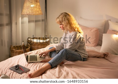 Smiling girl student study at home, skype teacher, happy young woman learn language listen lecture watch webinar write notes look at laptop , distant education Royalty-Free Stock Photo #1648933156