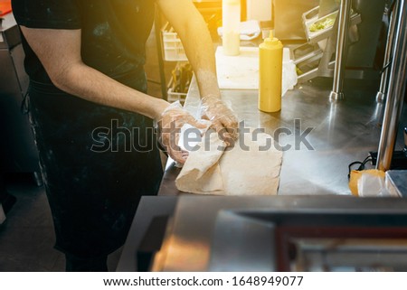 Cooking shawarma at stove in restaurant
